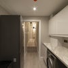 Photo 6: The utility room with washing machine, dryer (not shown) and fridge-freezer