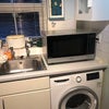 Photo 4: Washing machine & microwave in utility room