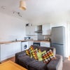 Photo 2: Spacious kitchen with oven, dishwasher and washing machine.