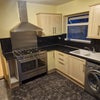 Photo 1: Kitchen with washing machine and fridge 