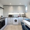 Photo 7: Kitchen with dining table, washing machine & small dishwasher