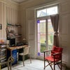 Photo 2: The room with doors leading outside.