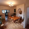 Photo 4: Dining room with laundry room to the right and kitchen beyond.
