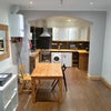 Photo 7: diner leads on to kitchen with fan oven and gas steel hob with steel extractor over