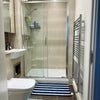 Photo 7: Storage cabinets and large mirror in bathroom