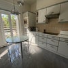 Photo 2: Kitchen leads onto terraceshower