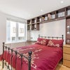 Photo 13: Bedroom 1 - desk, dressing table with illuminated mirror, double bed, and ample storage