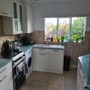 Photo 6: Shared kitchen Inc. electric hob, fridge, washing machine, dish washer and plenty of cupboard space.