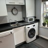 Photo 8: Kitchen with washer/dryer