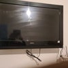 Photo 4: wall mounted TV with remote