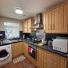 Photo 3: Kitchen with oven, hob, refrigerator and washing machine 