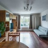 Photo 1: Living Room with TV, sofa, storage and dining table