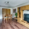 Photo 9: Living Room with TV, sofa, storage and dining table