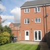 Photo 10: Rear of property with patio
