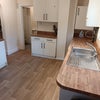 Photo 2: Kitchen view 1 with NEW FLOORING (from back door looking toward hallway door)