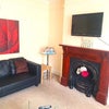 Photo 8: Sitting room with 3 leather sofas, coffee table & ornate fireplace.