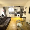 Photo 5: Kitchen living room with dining table chairs, leather sofa, TV, dishwasher, oven, microwave, kettle,