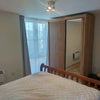 Photo 5: Furnished room with large West facing windows.