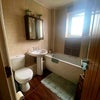 Photo 3: Shared Bathroom with electric shower over bath.