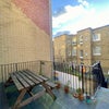 Photo 4: The outdoor balcony, with a large picnic table and a bbq