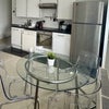 Photo 3: Large kitchen with table & 4 chairs. Large fridge freezer, dishwasher, hob, oven, kettle, toaster.