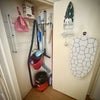 Photo 9: Shared utility cupboard in hallway with ironing board, iron holder, hoover, bags, mop bucket, drying