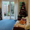 Photo 3: Living room with sofa and TV looking out on to private patio