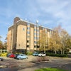 Photo 7: Building exterior with residential car park