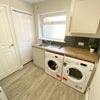 Photo 6: Utility Area with Washing Machine and Tumble Dryer