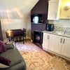 Photo 1: Sitting room-kitchen with TV 