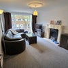 Photo 1: Sunny Living Room with large, comfy sofa and flat screen TV 