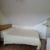Photo 9: View of bed and hanging storage end of bed