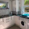 Photo 1: Kitchen has a washing machine and dryer