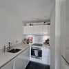 Photo 3: Kitchen, full size fridge to the right.