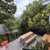 Photo 4: Sunny and spacious balcony with a comfy sofa, dining table, and leafy plants – the perfect spot to