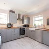 Photo 4: A spactious well-lit kitchen with premium wooden worktops.