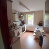 Photo 3: Kitchen with washing machine, fridge, freezer and basic equipment.