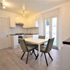 Photo 1: Kitchen ( table is not in the middle anymore)