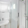 Photo 7: Modern, clean bathrooms with powerful shower and storage