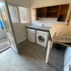 Photo 9: Communal area with washing machine and dryer. 
