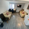 Photo 8: Communal seating area and kitchen.l