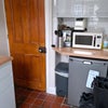 Photo 4: Door leading to basement with washine machine, extra fridge & freezer