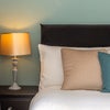 Photo 4: Fresh linens, hushed curtains wrap the day away.