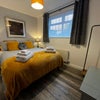 Photo 2: Bright and stylishbedroom with king-size bed and modern decor