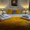 Photo 2: Shown with fresh towels and bedding (not included)