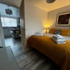 Photo 9: Warm, welcoming space with boutique touches and soft lighting
