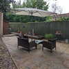 Photo 7: There is tidy garden with seating and umbrella