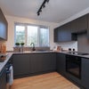 Photo 4: Handless Carbon Kitchen with Quartz Countertops