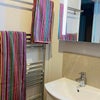 Photo 8: First floor shower room (shared): showing heated towel rail, basin and mirror cabinet..