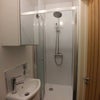 Photo 3: The en-suite includes a cubicle rainflow style shower, mirrored cupboard, sink and toilet.